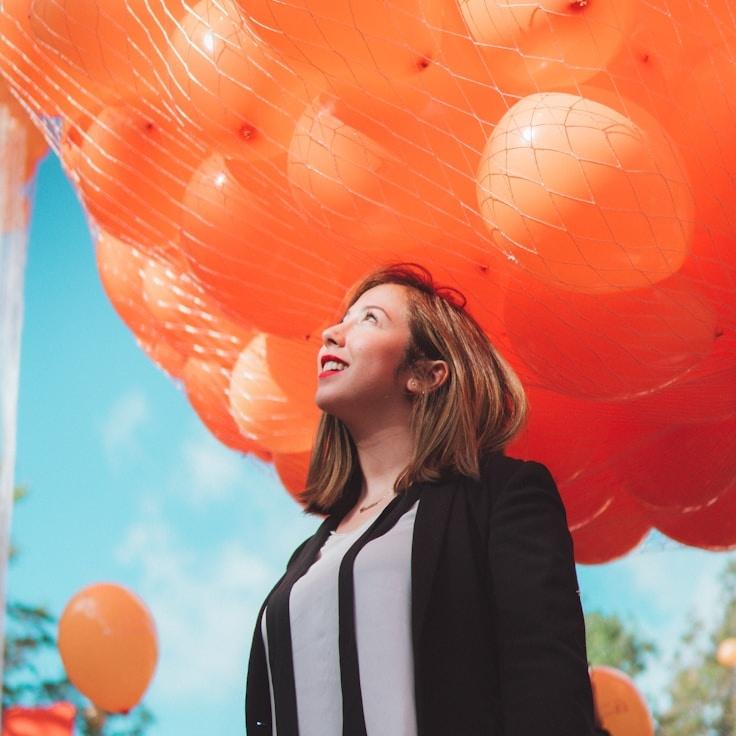 Aria Chen, Lead Design Curator at Luminous Growth Hub, reviewing corporate floral arrangements